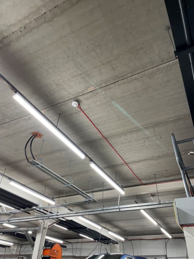 fire alarm system installed in the garage working area of a car dealership repair center in Glasgow