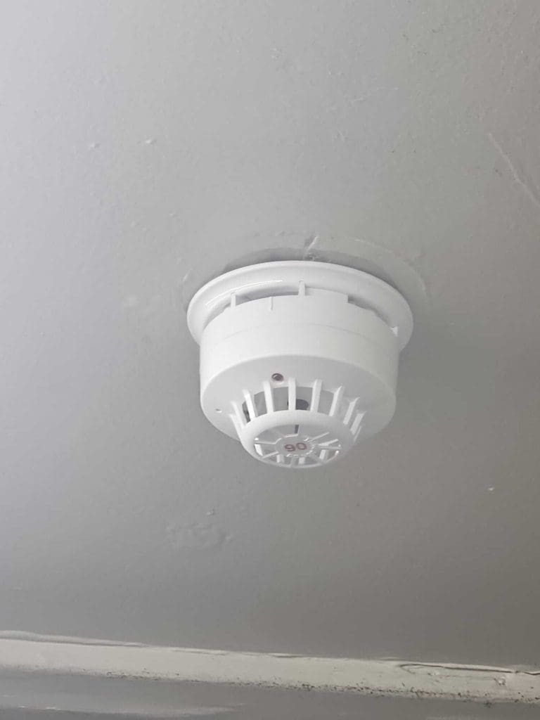 A close up view of a wireless smoke detector we have fitted at a pub in Glasgow