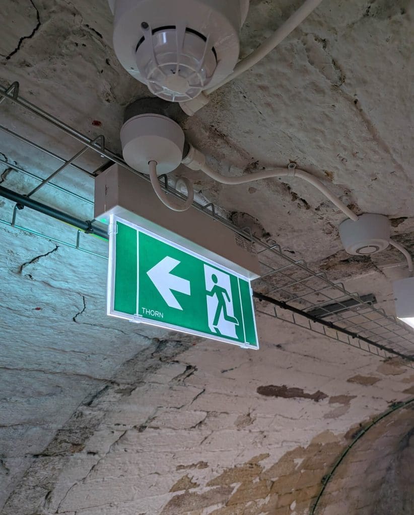 Fitting emergency lighting in the historic basement area of Maybole Castle.
