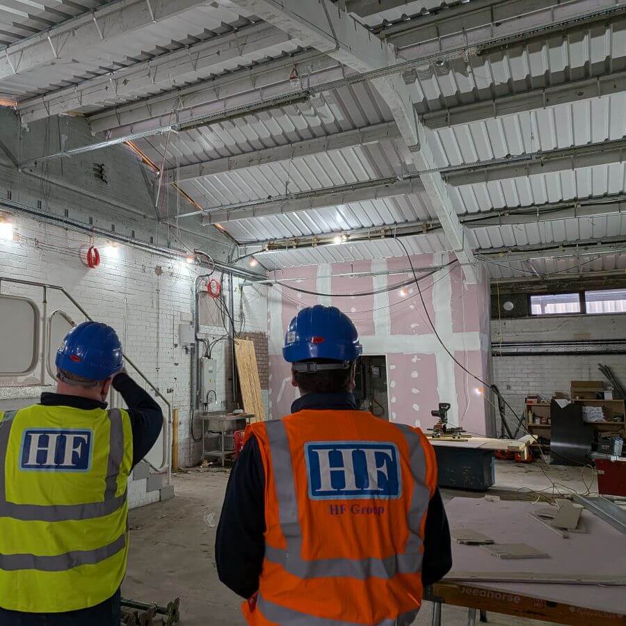 Electrical Director Niven discussing internal layout plans with Fire & Security Director James
