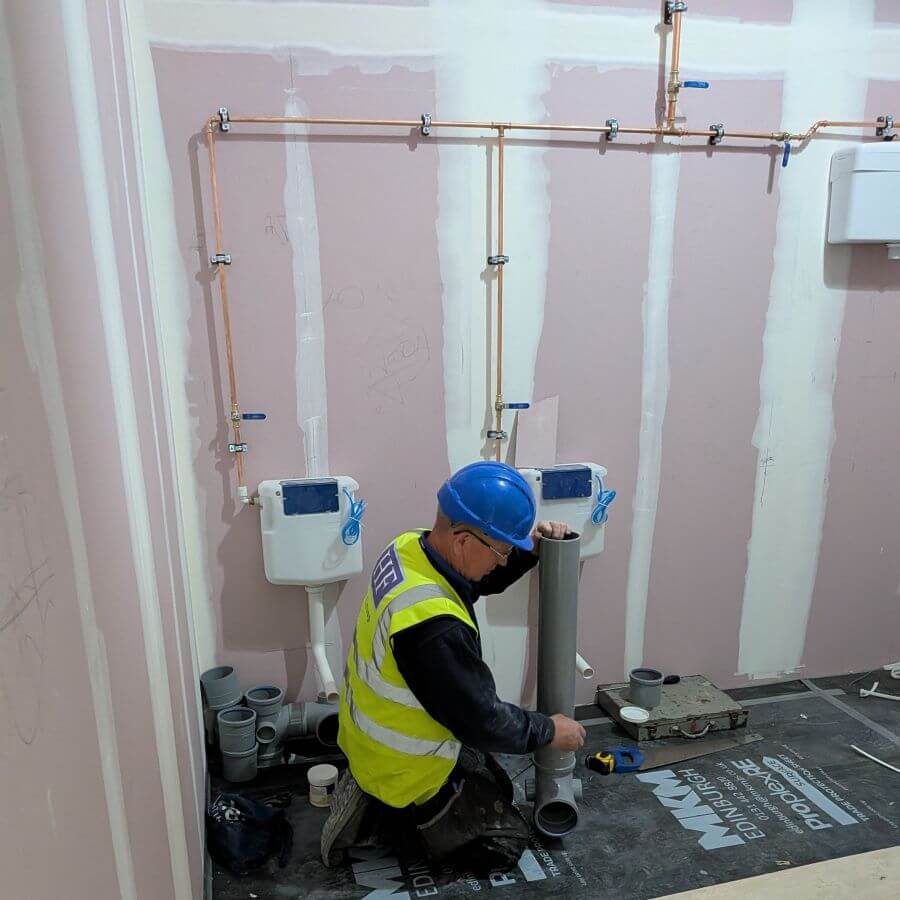 One of our Mechanical team installing pipework for the new office toilets.